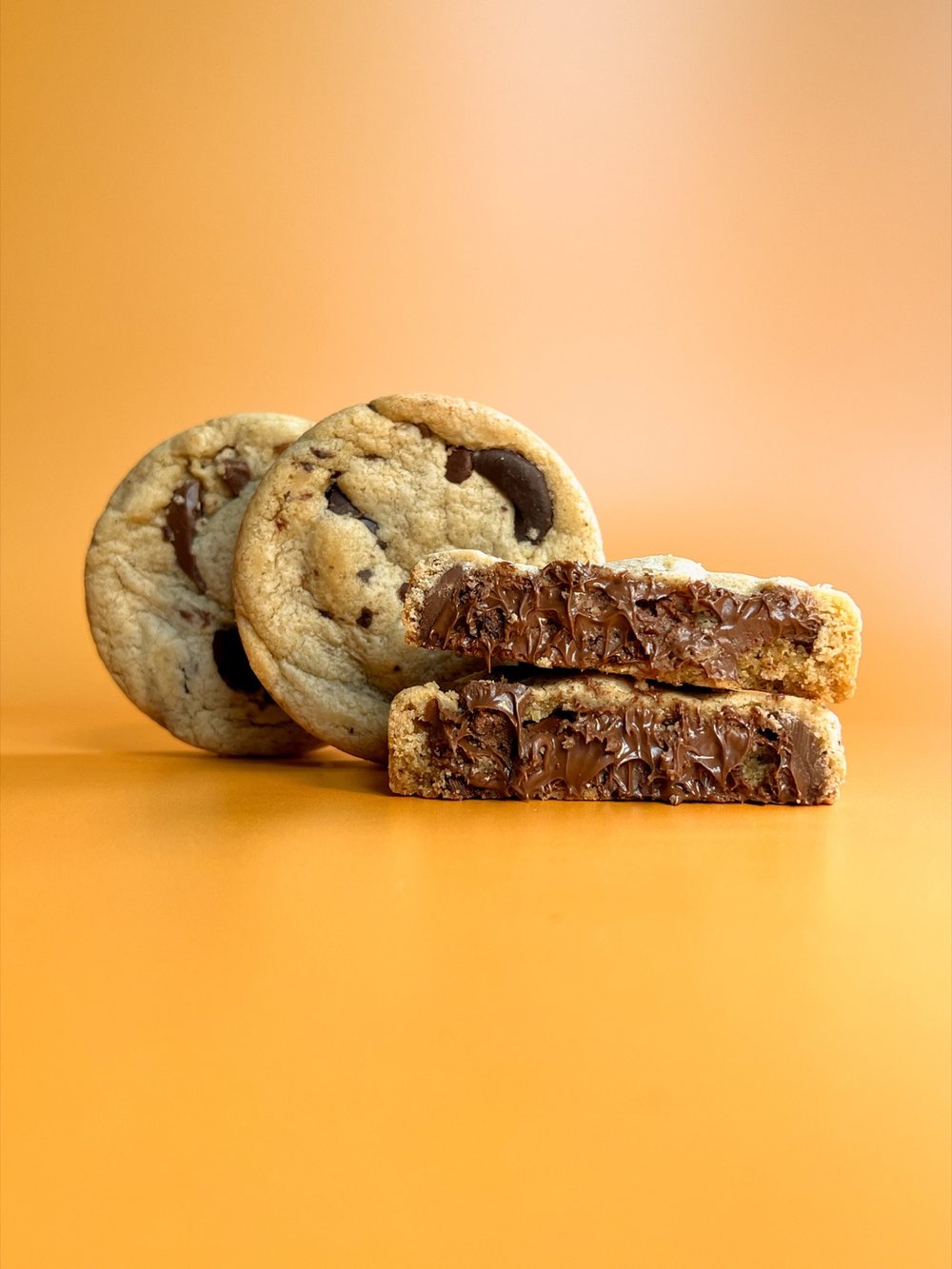 Nutella stuffed chocolate chip cookie, cut in half so the filling shows