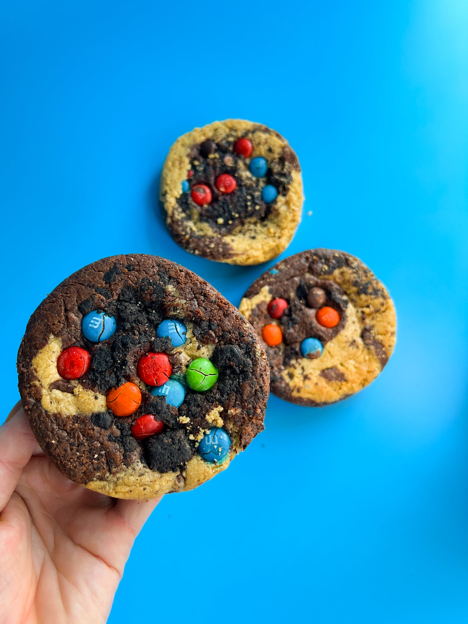 Inside Out Cookie Holding a brookie monster cookie