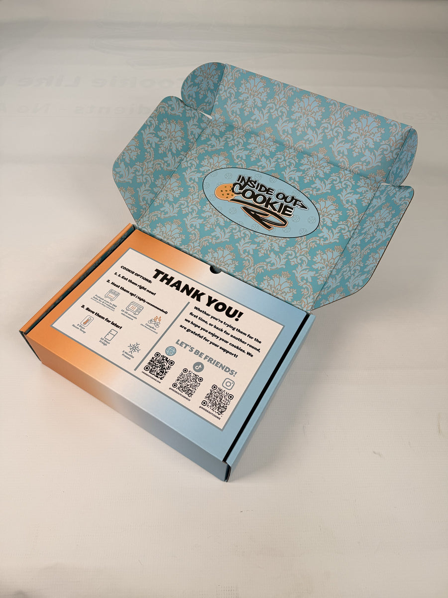 An open Inside Out Cookie box with the card that comes inside it