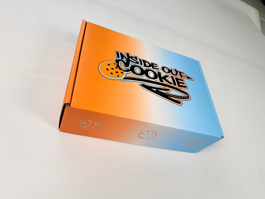 A closed Inside Out Cookie box, orange fading to blue