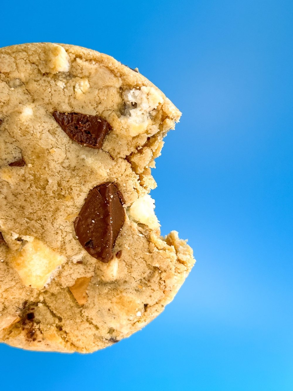 A stuffed cookie, cut open, showing the chocolate filling inside